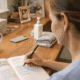 Therapy for Caregivers: Burnout Prevention 3 A caregiver sits at a desk, writing in a wellness planning journal to manage caregiver stress and prioritize their own health amidst caregiving responsibilities.
