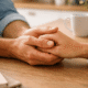 The image shows two hands gently holding each other, symbolizing support and connection, which are essential elements in a healthy relationship.