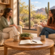Two Women Talking In A Warm, Sunlit Scottsdale Counseling Office With A Wooden Cross On The Shelf And A Saguaro Cactus Visible Through The Window